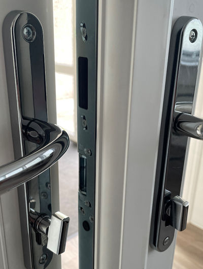 Close-up of a UPVC french door locking strip and handles