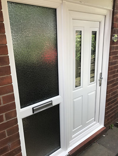 White UPVC door with midrailed side panel and textured backing glass
