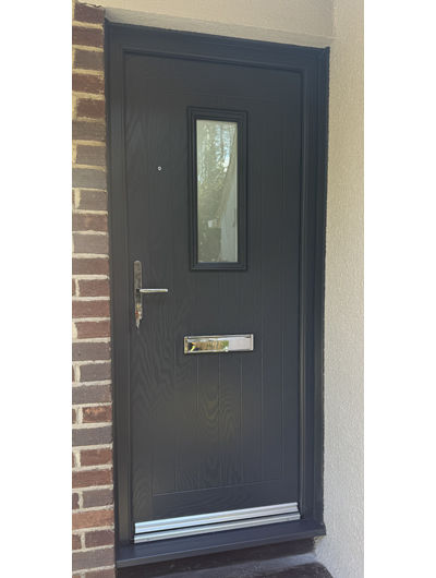 Cottage style composite front door with mid sized glass panel