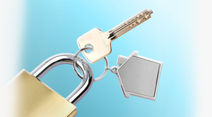 Key, house keychain and padlock on a keyring
