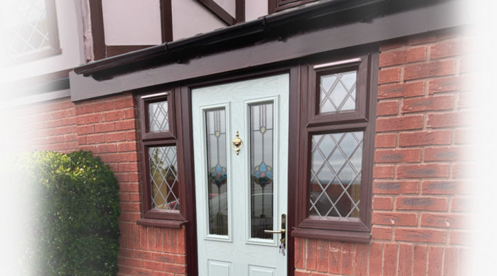 A light coloured composite door with rosewood frame matching surround