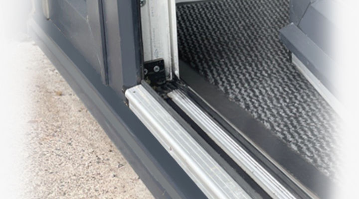 Closeup of a low aluminium threshold on an anthracite grey UPVC external door