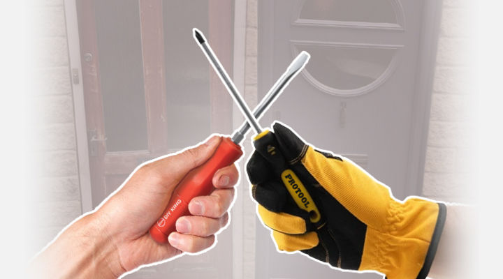 bare hand and gloved hand holding screwdrivers, crossed together over a background of old and new doors