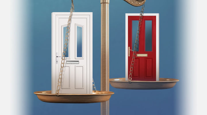 A white UPVC door and red composite door on a set of scales