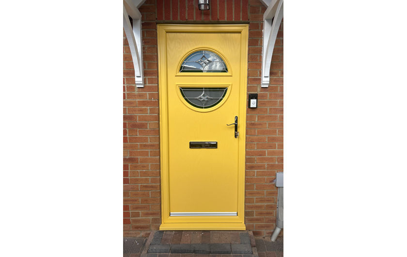 A modern twin half moon composite door in yellow