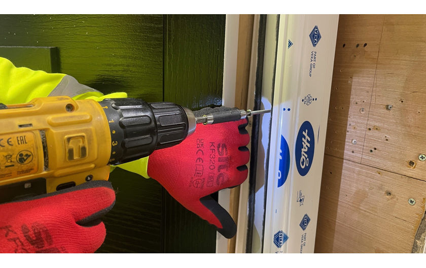 Workman screwing in a frame