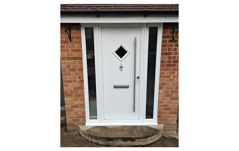 White cottage style composite front door with two side panels and a bar handle