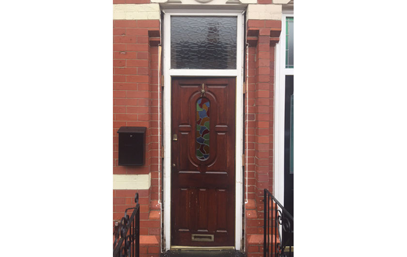 1930s style brown wooden door with toplight