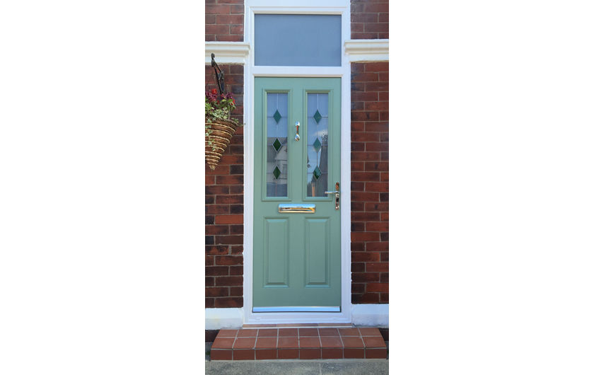 A chartwell green composite front door with white frame, Green Sextet glass and toplight, in a red brick house with white surround
